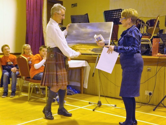 Rev. Graham Crawford receives farewell gifts from St James' Church, Lossiemouth