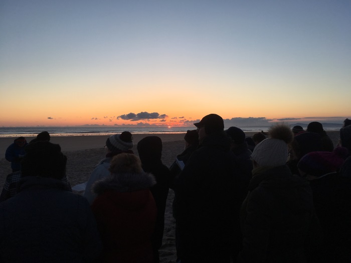 The sun begins to rise at the Easter Sunday Sunrise Service 2018, Lossiemouth, Moray