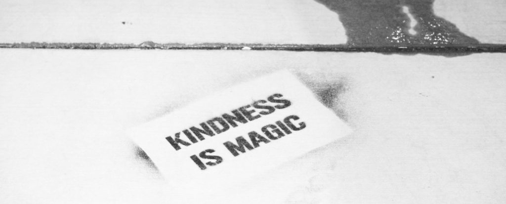 Stencil on pavement: Kindness is Magic